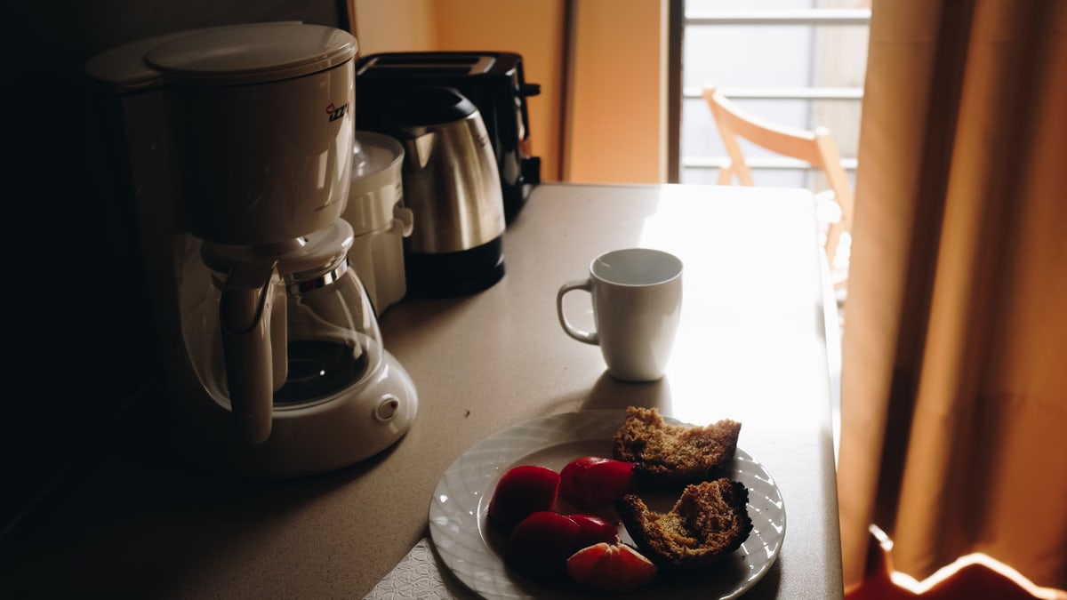 A serene morning setup with coffee and cake by the window in Chania, Greece.